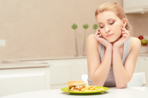 Young_Woman_Eating_Fast_Food_Meal_Alone